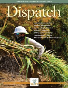 Magazine cover with worker in hard hat and bandana facecover hauling armfuls of Arundo